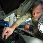 mechanic examining engine